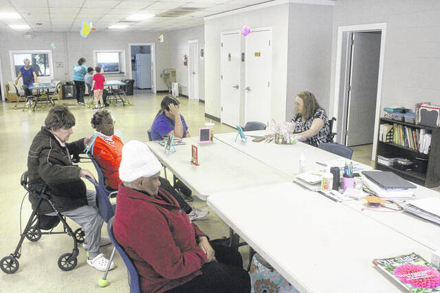 Clients at the Sampson County Adult Day Health Center participate in a number of fun activities each day. Here, several clients partake in an arts and crafts session with volunteers from the center lending a hand.
                                 Noah Britt | Sampson Independent