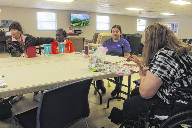 Clients at the Sampson County Adult Day Health Center participate in a number of fun activities each day. Here, several clients partake in an arts and crafts session with volunteers from the center lending a hand.
                                 Noah Britt | Sampson Independent