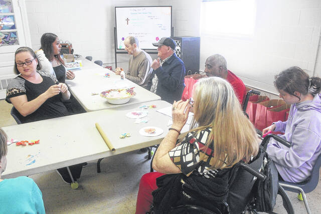 Clients at the Sampson County Adult Day Health Center participate in a number of fun activities each day. Here, several clients partake in an arts and crafts session with volunteers from the center lending a hand.
                                 Noah Britt | Sampson Independent