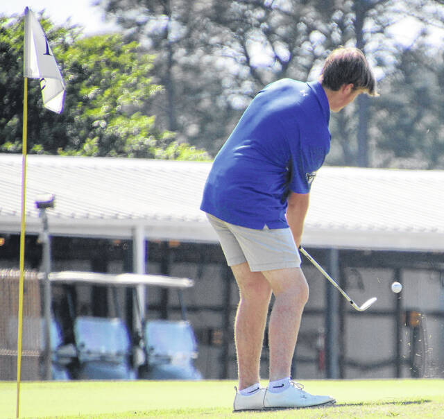 Sophomore Raider Jake Christopher takes a chip shot aiming for the pin.