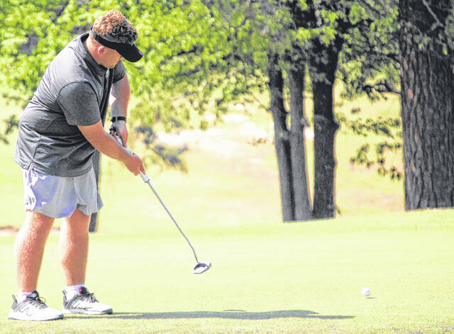 Clinton junior Landon Hill takes a putt attempt, trying to find the cup.