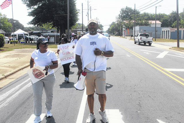 Andreana Sellers-Barksdale and George Cost Barksdale led a group of about 100 citizens in an anti-violence march on Saturday morning.
Noah Britt | Sampson Independent