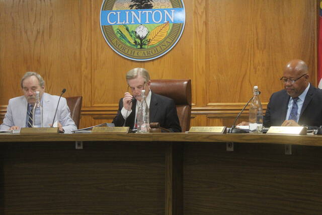 The city council reads over their agendas prior to the meeting held Tuesday night