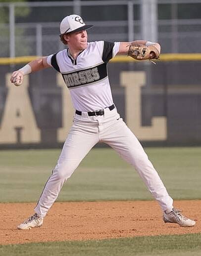 Clinton pitcher Tyler Hall hurls a throw to get a runner out at first base.