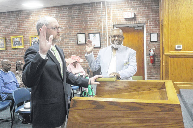 During Tuesdays Clinton City Council meeting, Ronald Sparks of Sparks Engineering, requested council approval of a plan to turn an existing structure into four apartments . Here, he is being sworn in by Clinton planning director Lyle Moore.