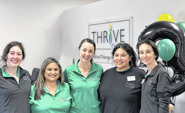 Leah Aycock, center, DPT and owner of Thrive Sampson Physical Therapy & Wellness on Sunset Avenue in Clinton, along with members of her staff, from left: Carrington Anderson, PTA, Bethany Williams, Ana Foday and Melissa Whaley, DPT pose for a photo during their week-long celebration of Thrives third anniversary. (Hendry Jones|Sampson Independent)