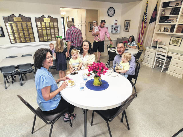 From left Mikayla, Amanda and Scott McLamb share time with children John and James McLamb