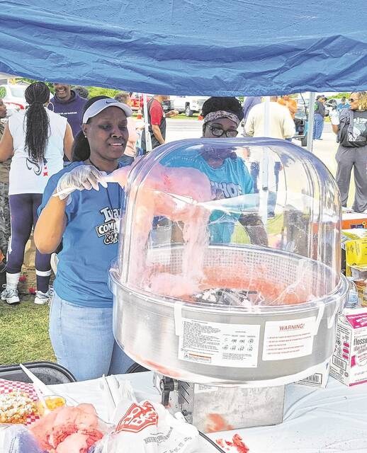 Keke McCoy spins a big serving of cotton candy during Saturdays Ivanhoe Community Day.