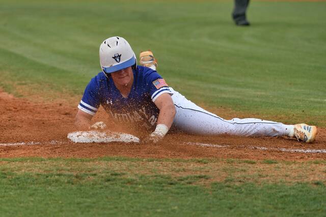Midway senior Wyatt Scott slides safely into third base during the first inning of Friday nights game against Greene Central.
