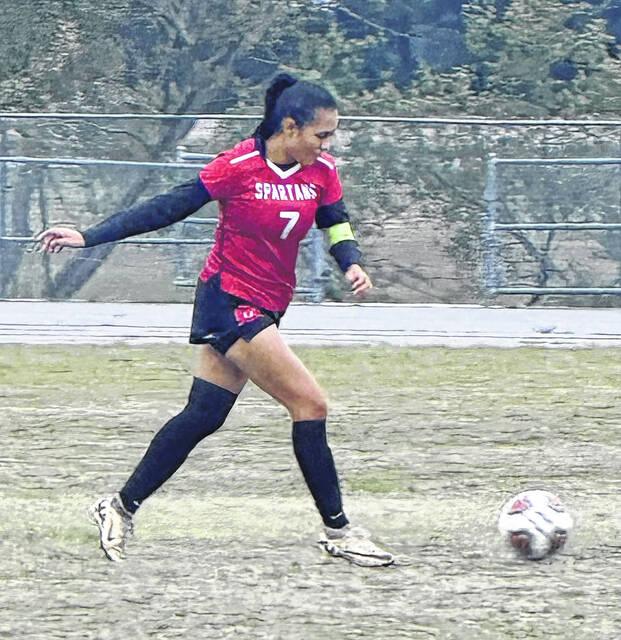 Senior Lady Spartan captain Kimberly Gomez sends a pass into the scoring box.