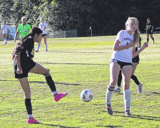 Hobbton High School Junior Aaliyah Garcia attempts a pass with a Raleigh Charter player attempting to block it.
Trevon McGlone| Sampson Independent