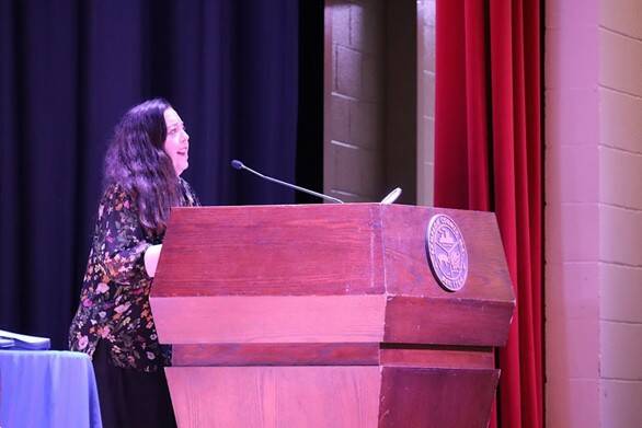 CHS Arts & Sciences instructor and drama teacher Angela Martin sings the National Anthem during the SCC commencement ceremony.