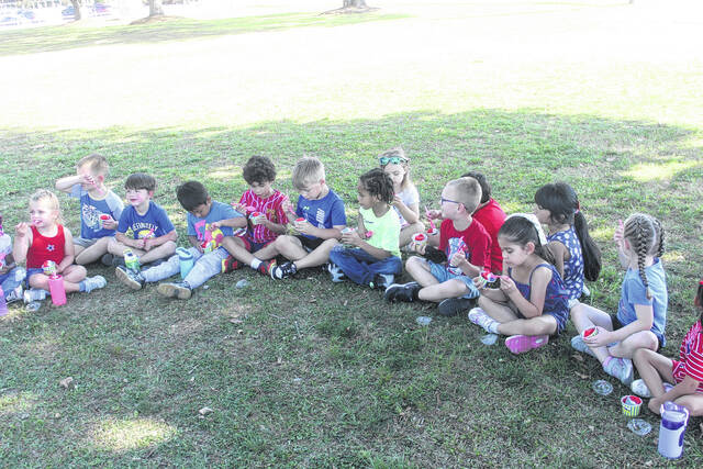 Clement Elementary kids enjoy slushies in the shade courtesy of sunset slush.