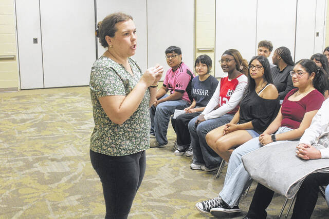 Ashley Stanley of Sampson Early College High School gives the class instructions during the practice run of the ceremony Thursday morning.