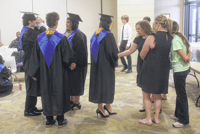 Prior to their Thursday ceremony, Sampson Early College High School graduates chat among themselves, eager to walk the stage