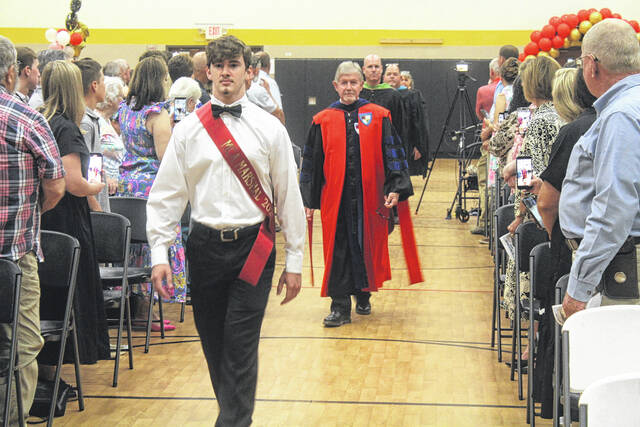 As Mintzs ceremony begins Thursday, Marshall Asher Embler leads the train of school officials and graduates