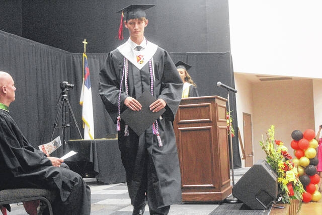 Peyton Beasly walks the stage at Mintz after being recognized as a top student of the class