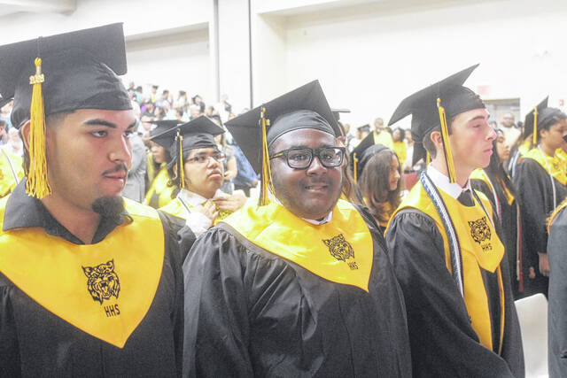Treshawn Bizzell, flanked by classmates, smiles as Hobbton Highs ceremony begins Friday just after noon.