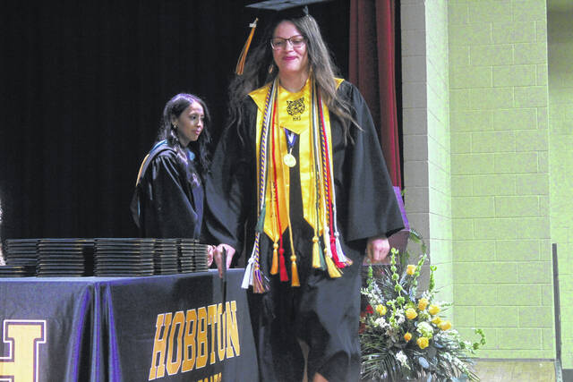 Hobbtons Cassie Driver walks the stage after being recognized as a top student during graduation ceremonies Friday.