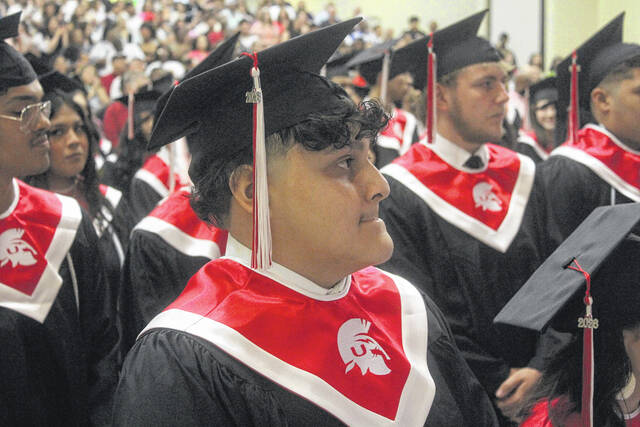 Union High graduate Christopher Acosta Garcia stands patiently in the crowds as he waits for his name to be called during graduation exercises Friday afternoon.