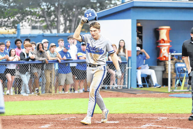 Midway sophomore Wesley Tew tips his cap as he crosses home plate after slamming a second-inning solo home run.
