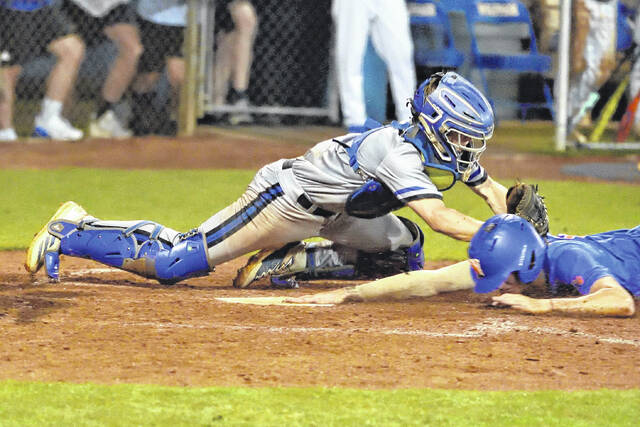Midway catcher Luke Peterson arrives just a fraction of a second late with the tag at home plate.