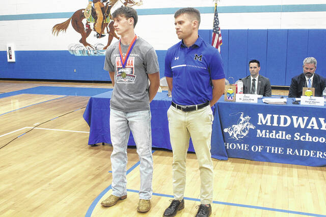 Samuel Dudley of Midway High was recognized for competing at the North Carolina High School Athletic Association 3A Track & Field State Championships in Greensboro. Here, he stands with Coach Zach Fann