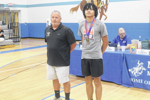 Tilyn Monk of Lakewood High School was recognized as state champion in the high jump at the North Carolina High School Athletic Association 2A State Championship. Here, he stands with Lakewood Athletic Director Darren Hulen