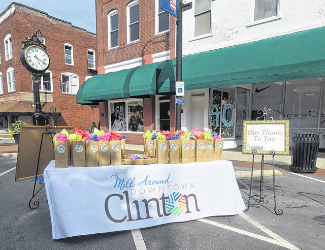 A table laden with colorful gift bags were on display at the downtown Rotary clock, a thank you to the attendees. Inside, a glass bottle affixed with Clintons millstone logo, perfect for holding the crisp, clean award-winning city water. (Sherry Matthews|Sampson Independent)