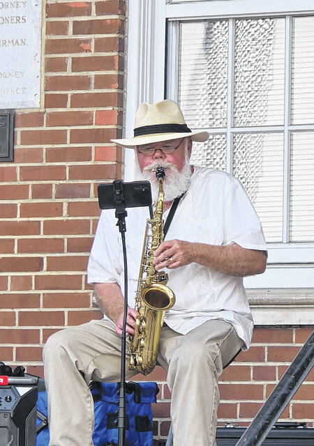 From his perch at the Sampson County Courthouse, saxophonist Carlton Smith delighted Dinner on Main guests with vibrant music as they enjoyed their dinner Sunday night along Main Street. (Sherry Matthews|Sampson Independent)