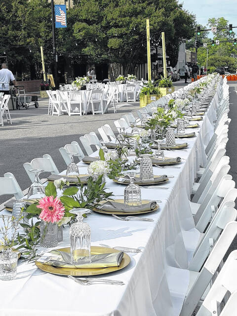 Tables, stretching nearly the length of downtown, were adorned with white tablecloths and beautiful table settings, dressed by Wendy Dorman, owner of Ranch QD in Clinton and accentuated thanks to the Atrium Florist. (Courtesy photo)