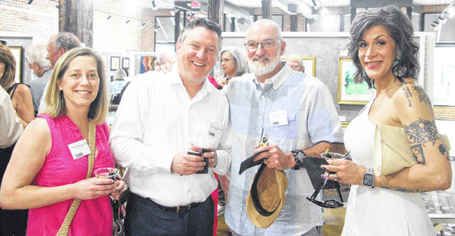 From left, Erin and Nicholas Ziolkowski, along with Charles Ray and Erica Knowles, pose for a group picture during the social hour outside of Artworks.
                                 A. Goodman | Sampson Independent