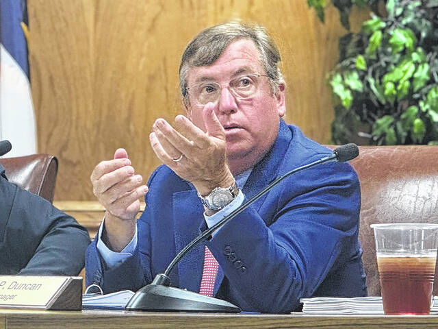 Clinton City Councilman Holden DuBose asks a question regarding possible ways to drain the storm water during a discussion with residence about their flooding problem.