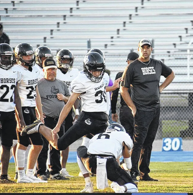 Jacob Baggett gets in a practice kick with the Clinton High Dark Horses during his time there.