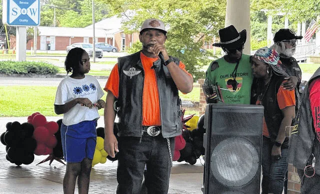 Luther Pegues, president of the Wyld Boar Ryderz, speaks to the crowd at the start of the Juneteenth parade Saturday morning.
                                 Trevon McGlone | Sampson Independent
