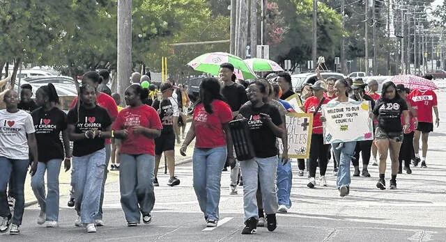 Participants of the Wyld Boar Ryderz Juneteenth Parade walk from the City Market in Clinton to celebrate the occasion.
                                 Trevon McGlone | Sampson Independent