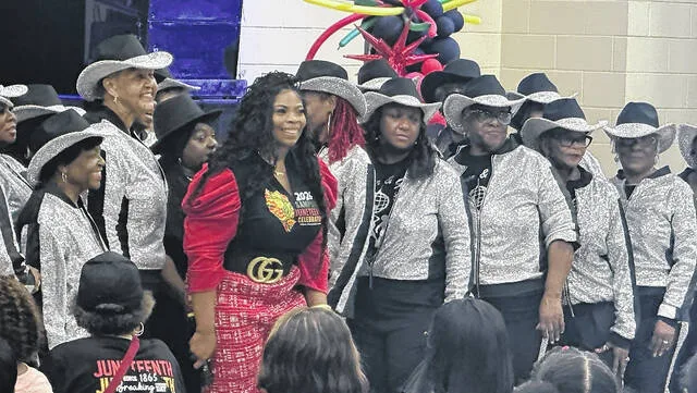 Stephaine Graham, event Coordinator of Sampsons Juneteenth and head of Community Uplift Initiatives, , takes a picture with the Silver and Gold Steppers after their dance performance. The Community Uplift Initiatives held its fourth annual event in its history on Friday, June 19.
                                 Trevon McGlone | Sampson Independent
