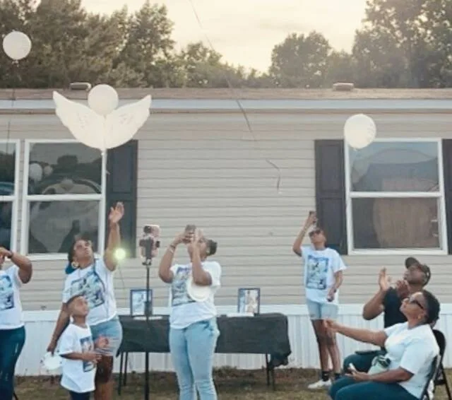 Family members release balloons into the sky in memory of Annie Faison, who was killed on May 20 when someone fired into her home.