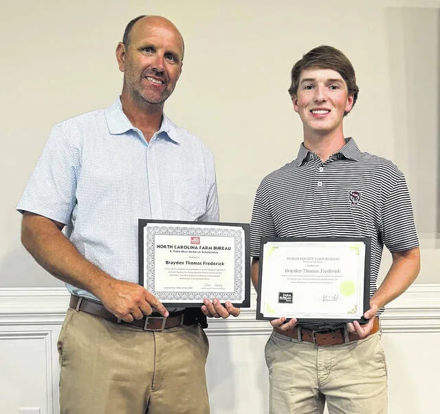 Justin Edwards, left, president, of the Duplin County Farm Bureau, presents an R. Flake Shaw Scholarship to Harrells Christian Academy graduate Brayden Frederick during a recent Farm Bureau board meeting. Frederick is the first Duplin County recipient of the scholarship named for Robert Flake Shaw, a native of Guilford County who served as executive vice president of the N.C. Farm Bureau Federation in 1940. The scholarships are awarded to students pursuing higher education in an agricultual-related discipline. Frederick will attend N.C. State University in the fall pursuing an ag degree. The scholarships have been awarded since 1967, providing over $3,000,000 to young people seeking an ag career. Frederick is the son of Bradley and Susan Frederick of Warsaw.
