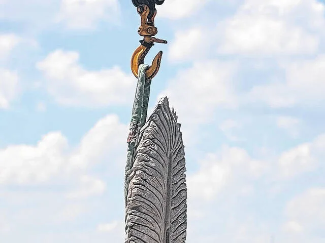Eagle Feather is placed in position as it begins its descent to its new location at the Coharie Tribal Center on U.S. 421, just north of Clinton.