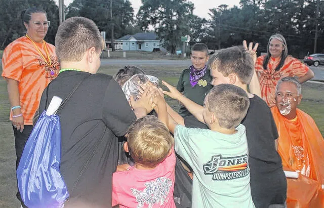 Over at Rowan Baptist Church, where the VBS theme was also Illumination Station, youngsters have a little fun with each other and pastor Clay Carter, far right, during outdoor activities that involved a lot of laughter and some creamy pie. (Courtesy photo)