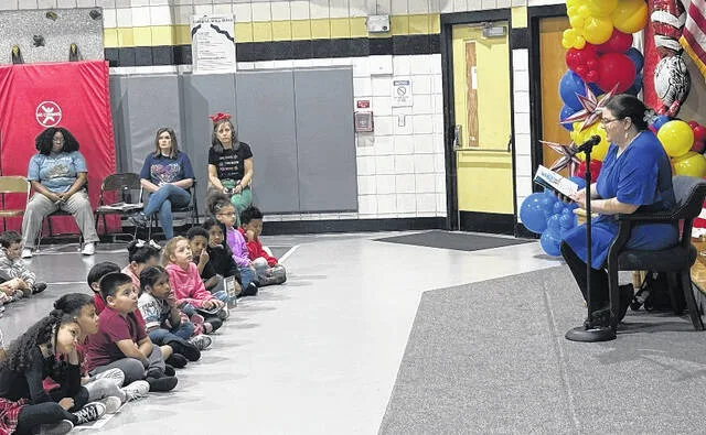 JC Holiday Library Director Kelsey Edwards reads to a handful of students at Butler Avenue Elementary during Read Across America Week.
                                 Trevon McGlone| Sampson Independent