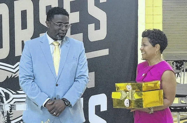 Patrick Cooper is welcomed onto the Clinton City Board of Education by vice chairwoman Carol Worley, who hands him gifts during the reception Tuesday afternoon.
Trevon McGlone | Sampson Independent