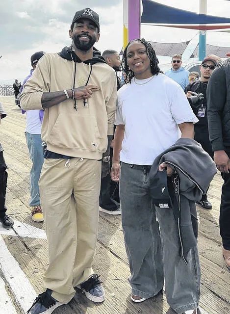 Mikayla Boykin seen here with Duke and NBA star Kyrie Irving while networking for her company MSpire Sports Group.