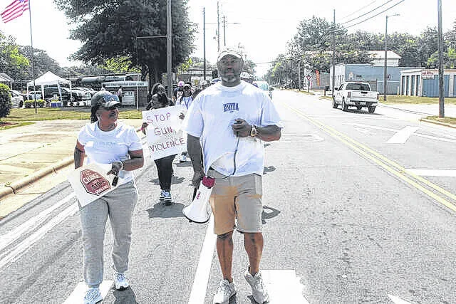 George and Andreana (Sellars) Barksdale lead a march of approximately 100 citizens earlier this year in Clinton, trying to bring awareness to the gun violence that has been occurring in the community.