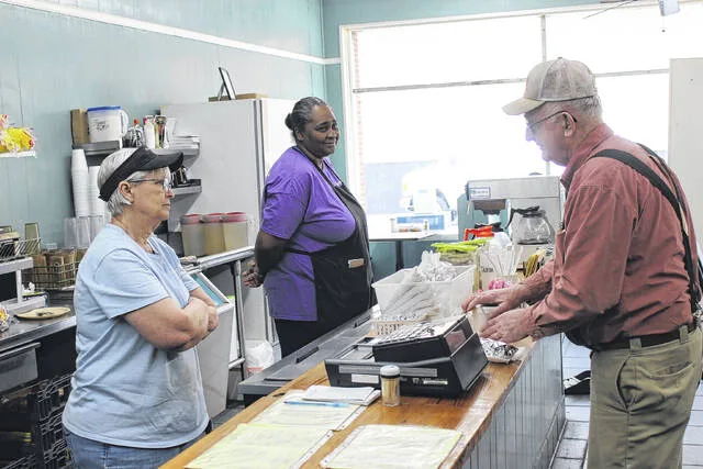 Former owner Sharon Royal, left, and Shirley Jones greet a customer at Sharons Country Diner in this file photo. Jones reflects on these moments and strives to bring them back.
