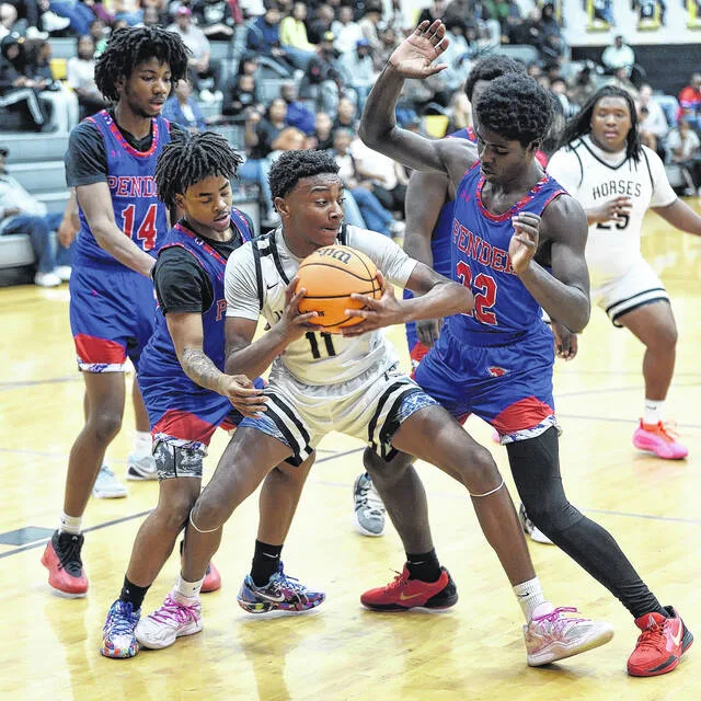 Ivey Sampson grabs a loose ball as he attempts to escape the pressure.