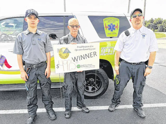 Suttontown EMSs new quick response vehicle will be easier to spot when racing to help the community thanks to new warning lights purchased with a grant through Operation Round Up. Pictured: Chase Jackson, Thomas Jackson and Chief Bradley Jackson