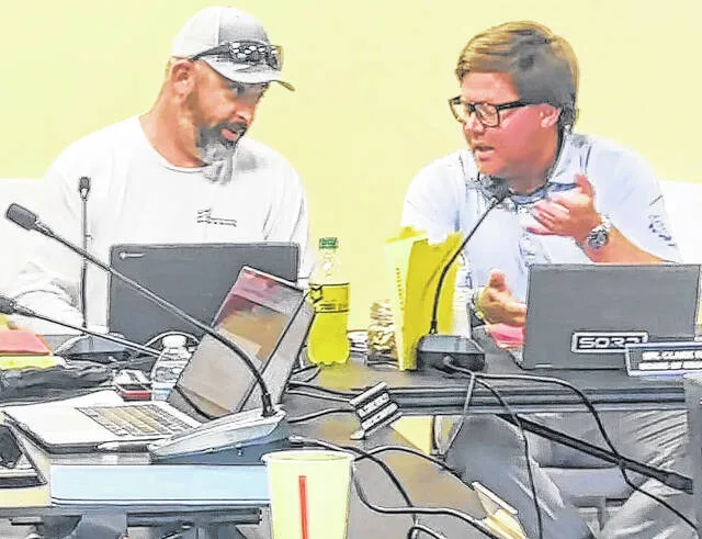 Clinton City Board of Education members Jeremy Edgerton, left, and Clark Hales discuss having chapels at each of the five schools in the district during Mondays meeting.