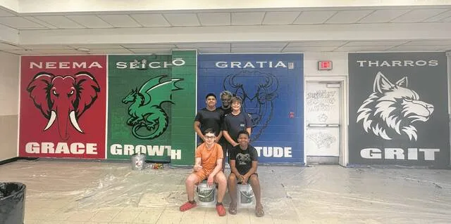 Art teacher Jemeikka Steele and some of the Roseboro-Salemburg students pose in front of the completed mural.